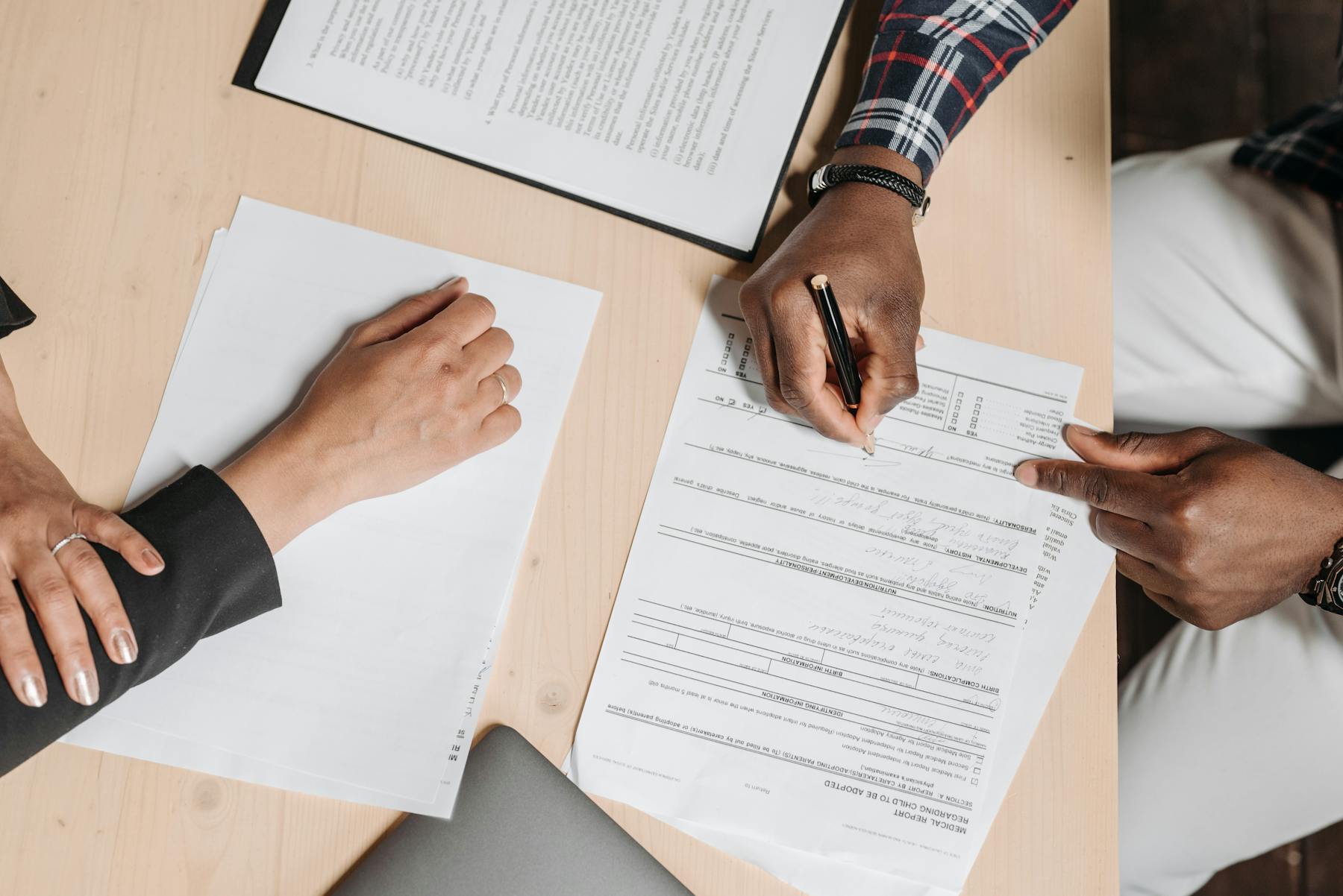 Advisor and client reviewing financial documents in an office